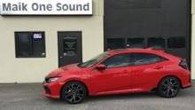 Red 2017 Honda Civic Hatch with dark privacy window tint